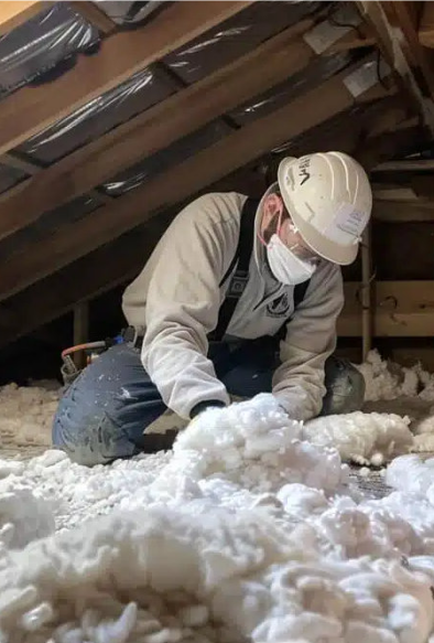 CT Insulation Services expert preparing to remove insulation from attic